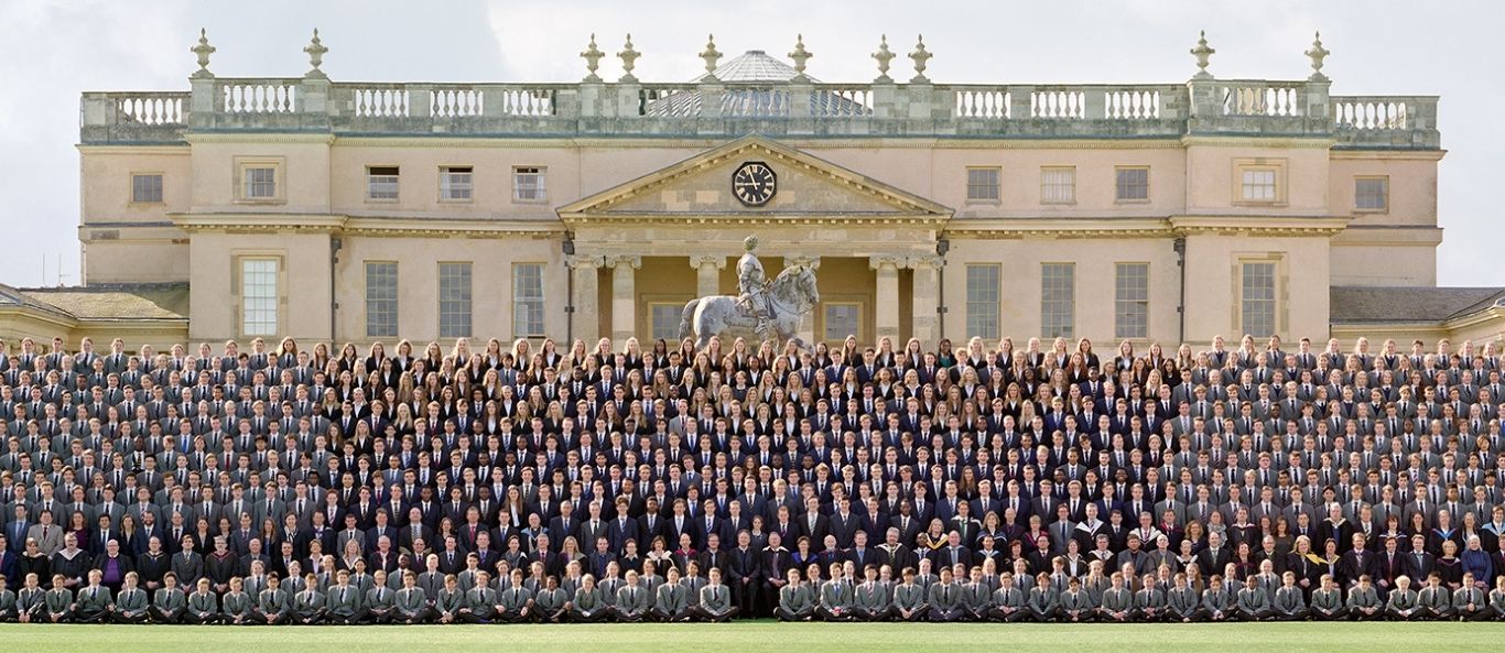 A whole-school group photographed on tiered staging, every face clear